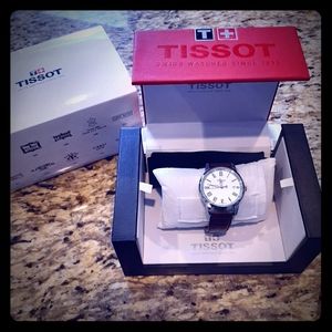Tissot watch with leather band and box.